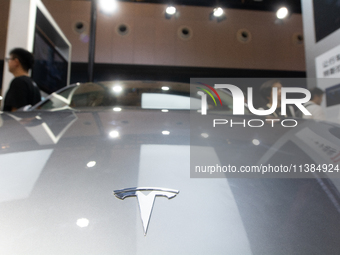 Visitors are being seen at the Tesla stand at the World Artificial Intelligence Conference at the Shanghai World Expo Exhibition Center in S...