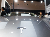 Visitors are being seen at the Tesla stand at the World Artificial Intelligence Conference at the Shanghai World Expo Exhibition Center in S...