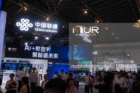 Visitors are being seen at the China Unicom stand at the World Artificial Intelligence Conference at the Shanghai World Expo Exhibition Cent...