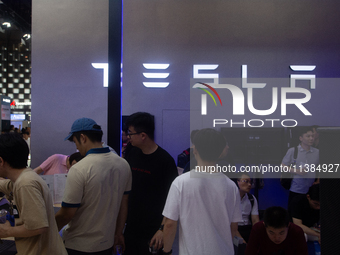 Visitors are being seen at the Tesla stand at the World Artificial Intelligence Conference at the Shanghai World Expo Exhibition Center in S...