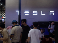 Visitors are being seen at the Tesla stand at the World Artificial Intelligence Conference at the Shanghai World Expo Exhibition Center in S...