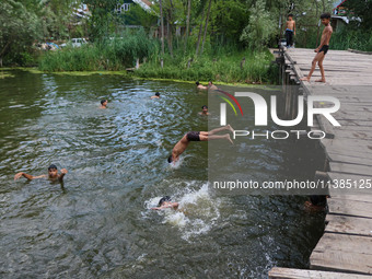 A boy is taking a dip into the waters of Dal Lake to cool off on a hot summer day in Srinagar, Jammu And Kashmir, on July 05, 2024. (