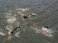 Kashmiri boys are swimming in the waters of Dal Lake to cool off on a hot summer day in Srinagar, Jammu And Kashmir, on July 05, 2024. (