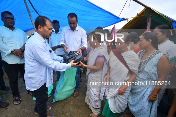 Flood-affected people are receiving relief distributed by Raijor Dal president and Sivasagar MLA Akhil Gogoi at a relief camp near Kampur in...