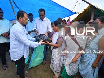 Flood-affected people are receiving relief distributed by Raijor Dal president and Sivasagar MLA Akhil Gogoi at a relief camp near Kampur in...