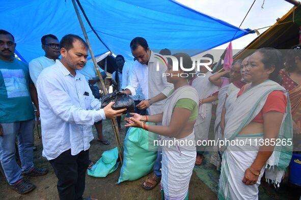 Flood-affected people are receiving relief distributed by Raijor Dal president and Sivasagar MLA Akhil Gogoi at a relief camp near Kampur in...