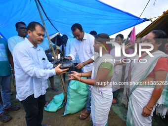 Flood-affected people are receiving relief distributed by Raijor Dal president and Sivasagar MLA Akhil Gogoi at a relief camp near Kampur in...