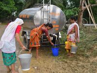 Flood-affected villagers are collecting drinking water from a relief camp conducted by the Public Health Centre (PHC) near Kampur in Nagaon...