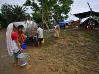 Flood-affected villagers are collecting drinking water from a relief camp conducted by the Public Health Centre (PHC) near Kampur in Nagaon...