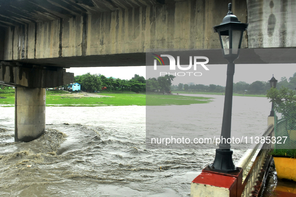 The Mahananda River water level is rising and flowing in Siliguri, India, on July 5, 2024. 