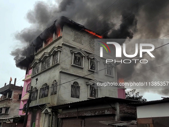 A fire tender vehicle is dousing a fire at a residential apartment in Majhabari village area near Siliguri, India, on July 5, 2024. A fire i...