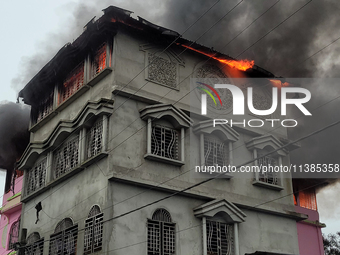 A fire tender vehicle is dousing a fire at a residential apartment in Majhabari village area near Siliguri, India, on July 5, 2024. A fire i...