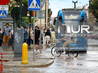 Flooding is occurring due to a water mains failure near the former Main Post Office in Krakow, Poland, on July 4, 2024. (