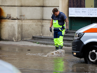 Emergency water supply is being provided during flooding due to a water mains failure near the former Main Post Office in Krakow, Poland, on...