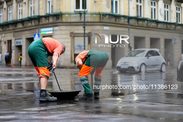 Emergency water supply is being provided during flooding due to a water mains failure near the former Main Post Office in Krakow, Poland, on...