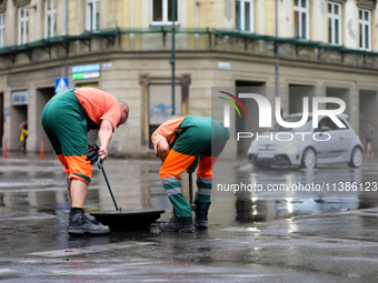 Emergency water supply is being provided during flooding due to a water mains failure near the former Main Post Office in Krakow, Poland, on...