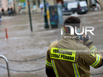 The fire brigade is responding to flooding due to a water mains failure near the former Main Post Office in Krakow, Poland, on July 4, 2024....