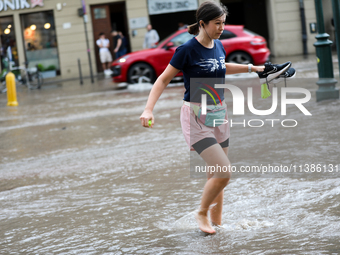 Flooding is occurring due to a water mains failure near the former Main Post Office in Krakow, Poland, on July 4, 2024. (