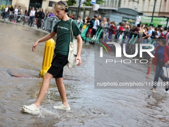 Flooding is occurring due to a water mains failure near the former Main Post Office in Krakow, Poland, on July 4, 2024. (