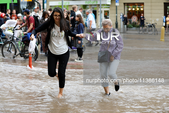 Flooding is occurring due to a water mains failure near the former Main Post Office in Krakow, Poland, on July 4, 2024. 