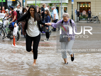 Flooding is occurring due to a water mains failure near the former Main Post Office in Krakow, Poland, on July 4, 2024. (