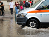 Emergency water supply is being provided during flooding due to a water mains failure near the former Main Post Office in Krakow, Poland, on...