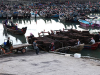 Fishermen are transferring abalone cages from their fishing boat to shore at Songluwan Pier in Fuzhou, Fujian province, China, on July 5, 20...