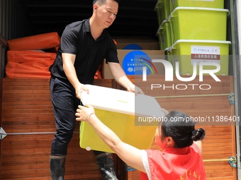 Volunteers are bringing emergency supplies to villagers in Si 'an village, Rongan County, Liuzhou city, South China's Guangxi Zhuang Autonom...