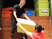 Volunteers are bringing emergency supplies to villagers in Si 'an village, Rongan County, Liuzhou city, South China's Guangxi Zhuang Autonom...