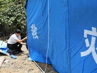 Volunteers are setting up tents for disaster-hit villagers in Si 'an village, Rongan county, Liuzhou city, South China's Guangxi Zhuang Auto...