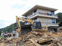 Workers are cleaning up collapsed houses in Si'an village, Rongan county, Liuzhou city, South China's Guangxi Zhuang Autonomous region, in L...