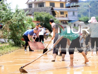 Villagers are cleaning up silt in Si 'an village, Rongan county, Liuzhou city, South China's Guangxi Zhuang Autonomous region, in Liuzhou, C...