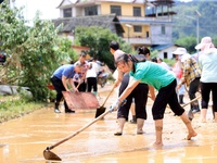 Villagers are cleaning up silt in Si 'an village, Rongan county, Liuzhou city, South China's Guangxi Zhuang Autonomous region, in Liuzhou, C...