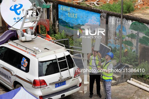 The emergency communication base station is being put away after the fixed communication base station signal is restored in Si'an Village, R...