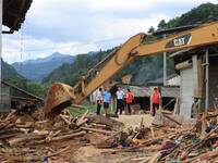 Workers are cleaning up collapsed houses in Si'an village, Rongan county, Liuzhou city, South China's Guangxi Zhuang Autonomous region, in L...