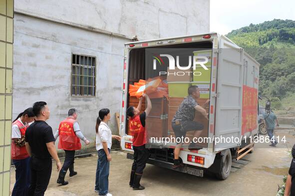 Volunteers are bringing emergency supplies to villagers in Si 'an village, Rongan County, Liuzhou city, South China's Guangxi Zhuang Autonom...