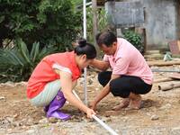 A worker is setting up tents for villagers in Si'an village, Rongan county, Liuzhou, China, on July 5, 2024. (