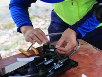 A staff member is repairing a damaged communication base station in Si 'an village, Rongan county, Liuzhou city, South China's Guangxi Zhuan...