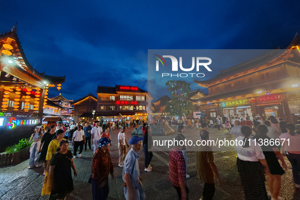 Tourists are enjoying Tea Horse Ancient City in Pu'er, Yunnan province, China, on July 1, 2024. 