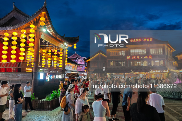 Tourists are enjoying Tea Horse Ancient City in Pu'er, Yunnan province, China, on July 1, 2024. 