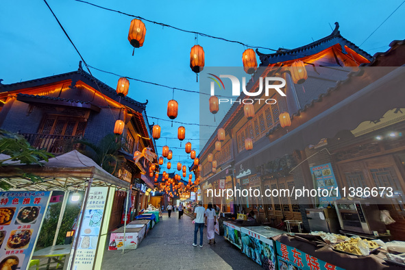 Tourists are enjoying Tea Horse Ancient City in Pu'er, Yunnan province, China, on July 1, 2024. 