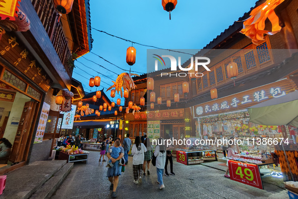 Tourists are enjoying Tea Horse Ancient City in Pu'er, Yunnan province, China, on July 1, 2024. 