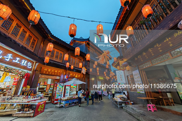 Tourists are enjoying Tea Horse Ancient City in Pu'er, Yunnan province, China, on July 1, 2024. 