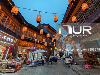 Tourists are enjoying Tea Horse Ancient City in Pu'er, Yunnan province, China, on July 1, 2024. (