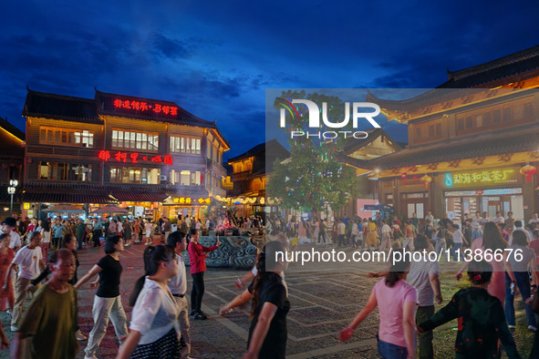 Tourists are enjoying Tea Horse Ancient City in Pu'er, Yunnan province, China, on July 1, 2024. 