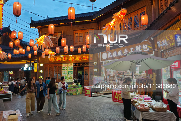 Tourists are enjoying Tea Horse Ancient City in Pu'er, Yunnan province, China, on July 1, 2024. 