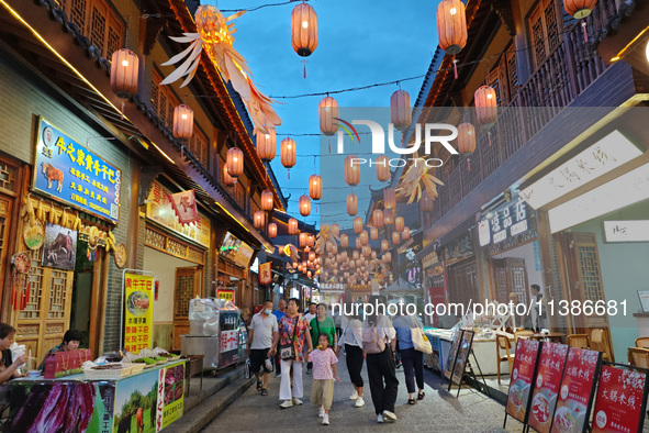 Tourists are enjoying Tea Horse Ancient City in Pu'er, Yunnan province, China, on July 1, 2024. 