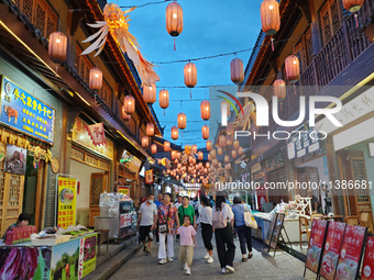 Tourists are enjoying Tea Horse Ancient City in Pu'er, Yunnan province, China, on July 1, 2024. (