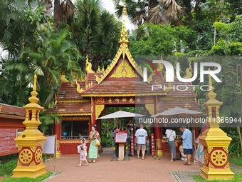 Tourists are enjoying the scenery in the Manting Imperial Garden in Xishuangbanna, China, on July 3, 2024. (