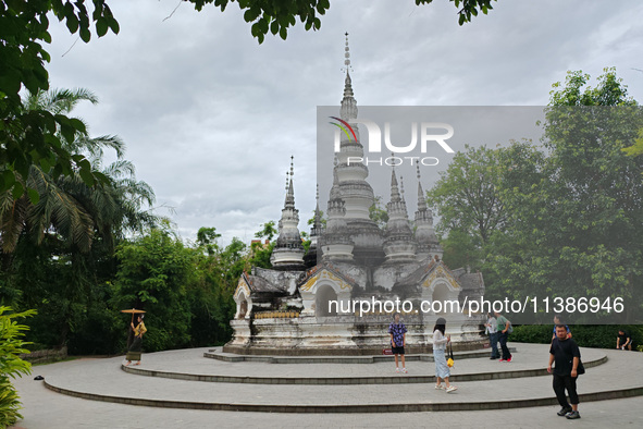 Tourists are enjoying the scenery in the Manting Imperial Garden in Xishuangbanna, China, on July 3, 2024. 